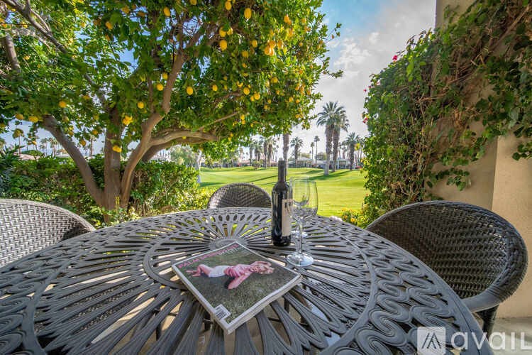A table with a menu and a bottle of wine on it.
