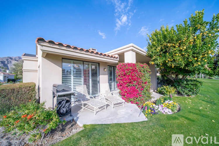 A house with a patio and a chair set.