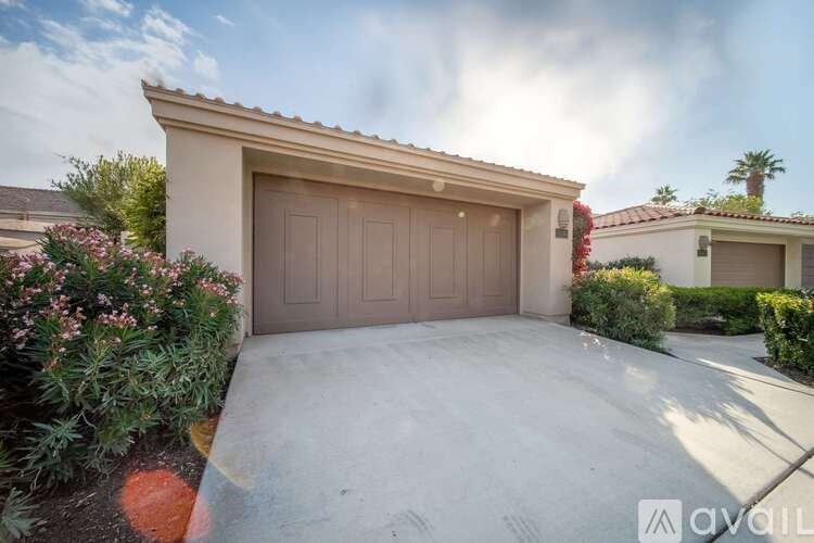 A house with a brown garage door and a driveway.