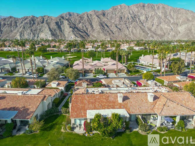 A neighborhood with houses and a mountain in the background.