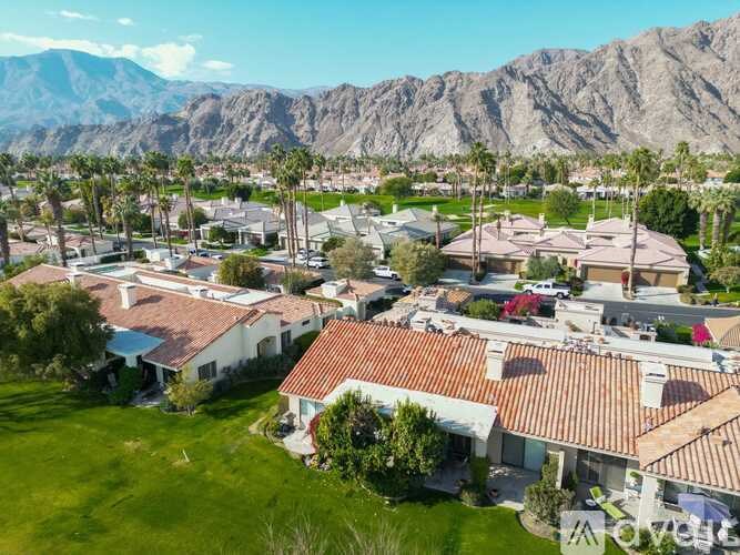 A bird's eye view of a neighborhood with houses and palm trees.