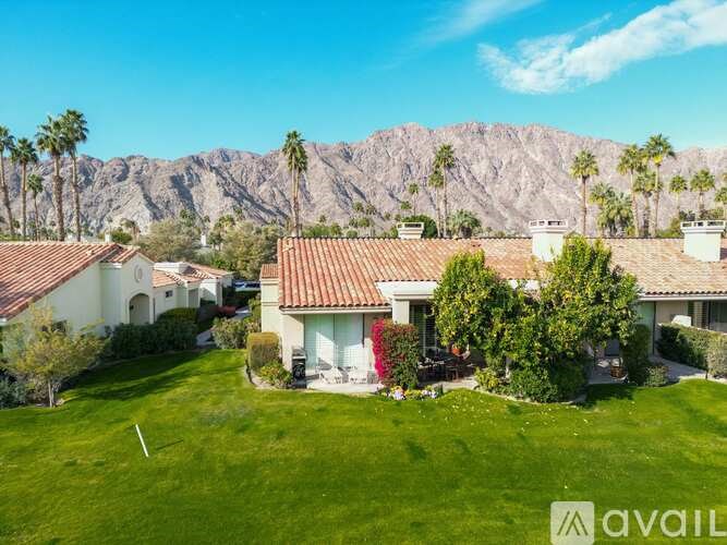 A house with a mountain in the background is for sale.