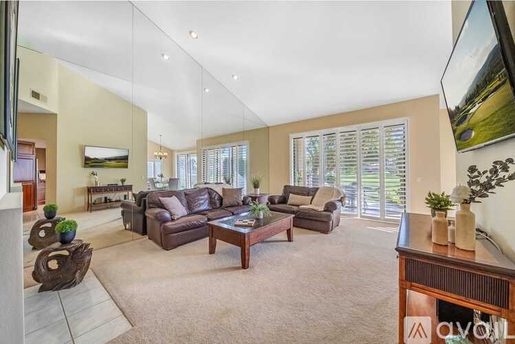 A spacious living room with a large couch and a coffee table.