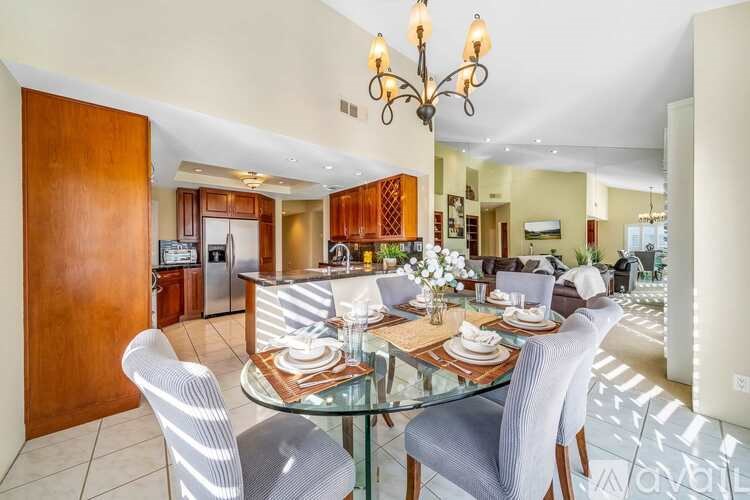 A dining room with a glass table and chairs.