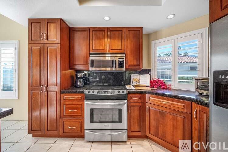 A kitchen with wooden cabinets and stainless steel appliances.