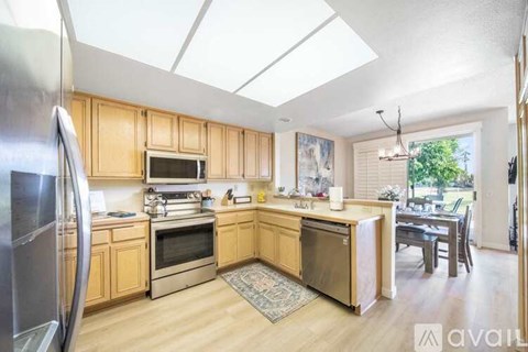 A kitchen with wooden cabinets and stainless steel appliances.
