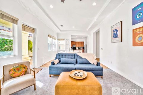 A living room with a blue couch and a wooden coffee table.