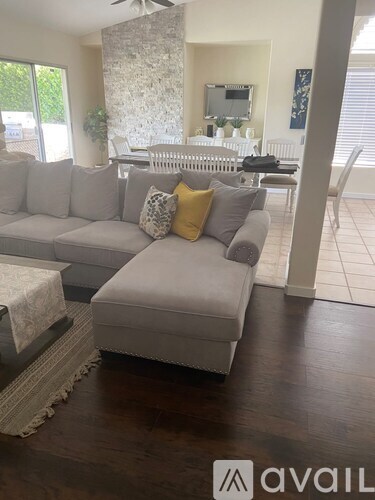 A living room with a grey couch and a white radiator.