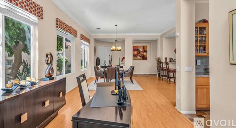 A modern kitchen with a dining table and chairs.