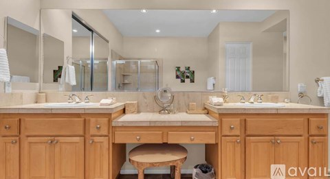 A bathroom with two sinks and a large mirror.