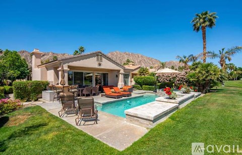 A house with a pool and a mountain in the background.
