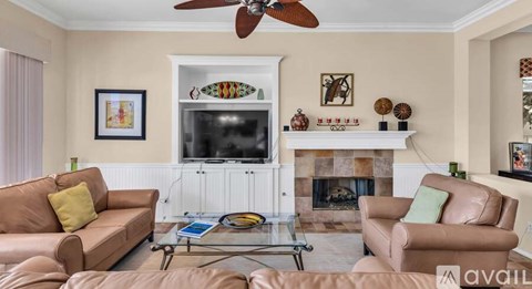 A living room with a fireplace and a television.