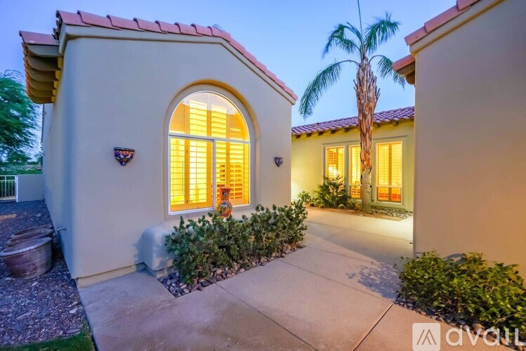 A house with a palm tree in front of it.