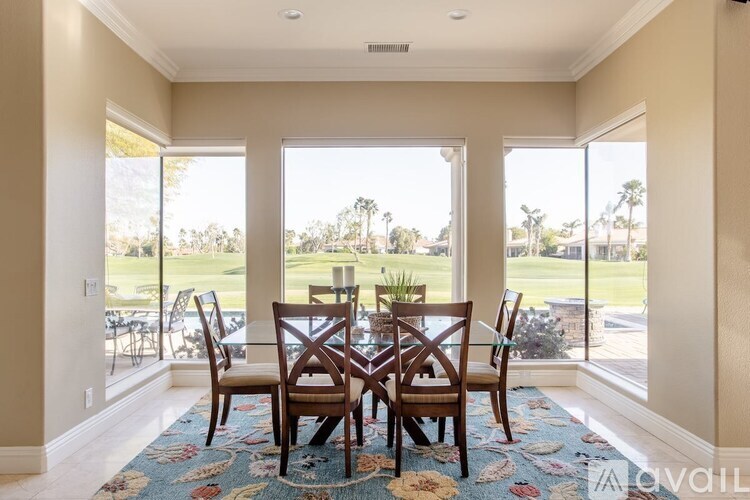 A dining room with a table set for six.