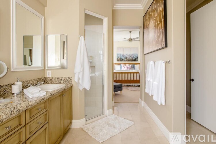 A bathroom with a marble countertop and a walk-in shower.