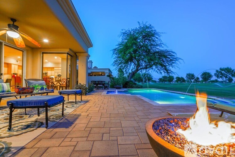 A backyard with a fire pit and a pool.