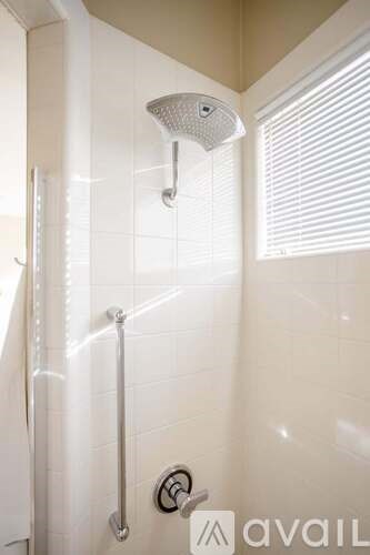 A shower with a glass door and a glass shower head.