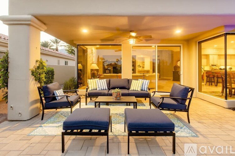 A patio with furniture and a pillow is available.