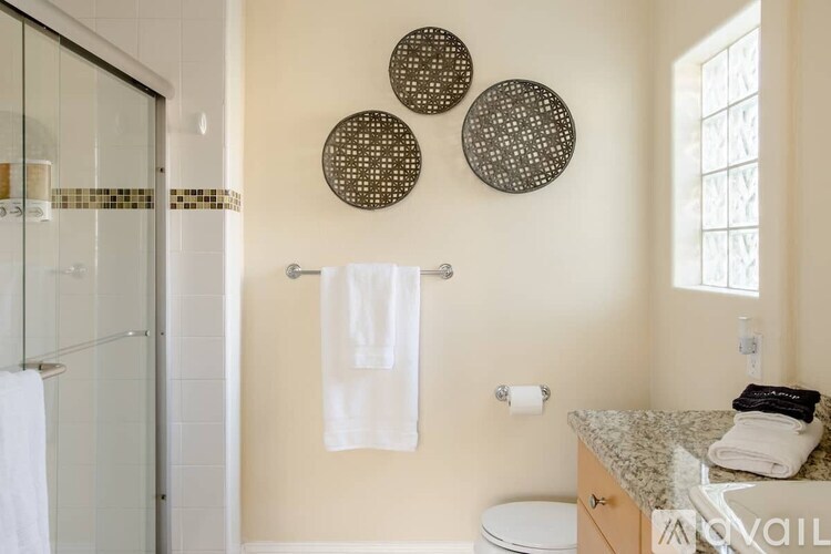 A bathroom with a toilet, sink, and shower.