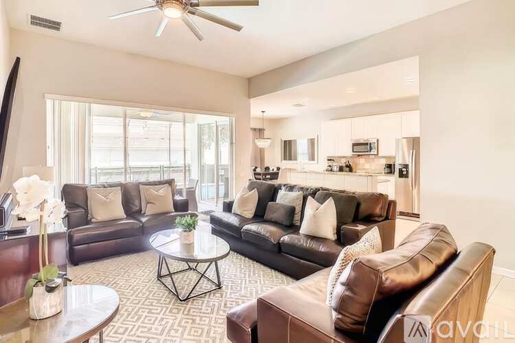 A living room with brown leather couches and a coffee table.