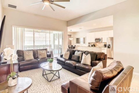 A living room with brown leather couches and a coffee table.