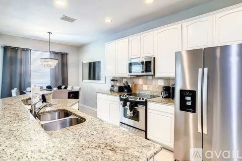 A kitchen with granite countertops and stainless steel appliances.