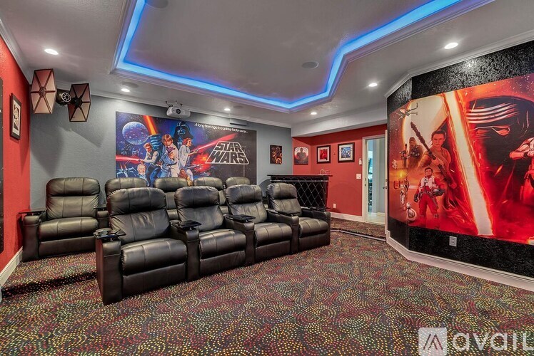 A room with a Star Wars theme and a row of black leather chairs.