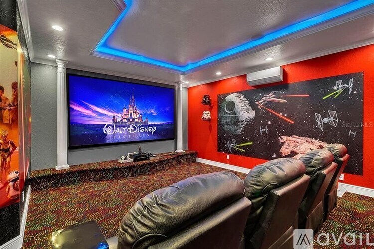 A home theater room with a Walt Disney logo on the screen.