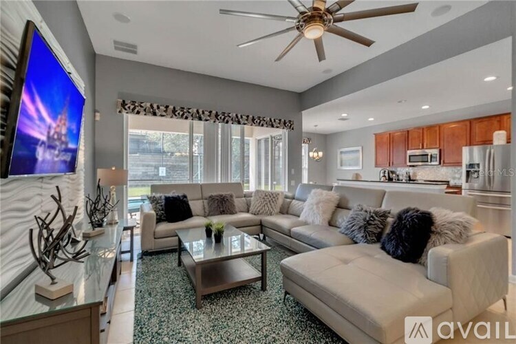 A modern living room with a flat screen TV mounted on the wall.