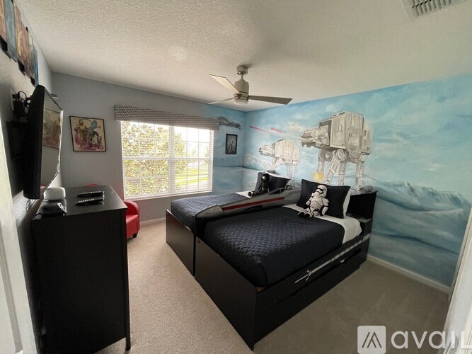 A room with a bed, a dresser, and a wall mural of a space scene.