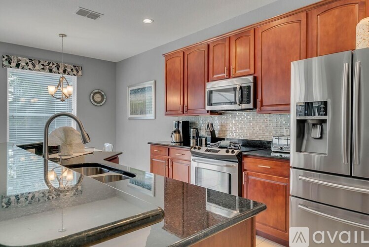 A kitchen with wooden cabinets and stainless steel appliances.
