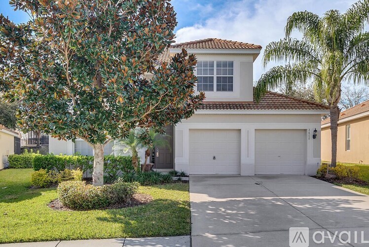 A house with a tree in front of it is for sale.