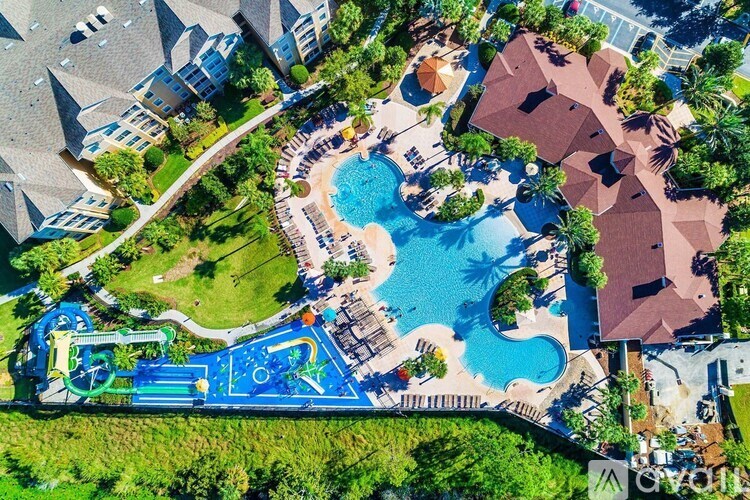 A bird's eye view of a residential area with a swimming pool and a playground.
