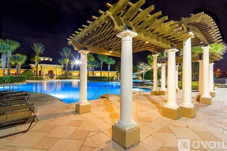 A pool area with a canopy and columns.