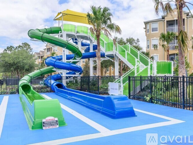 A playground with a blue and green slide and a yellow and green structure.