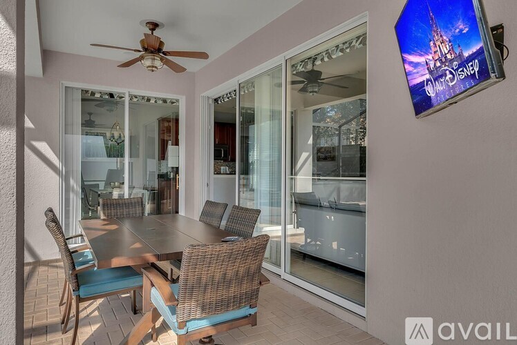 A Disney logo is on a wall above a television.