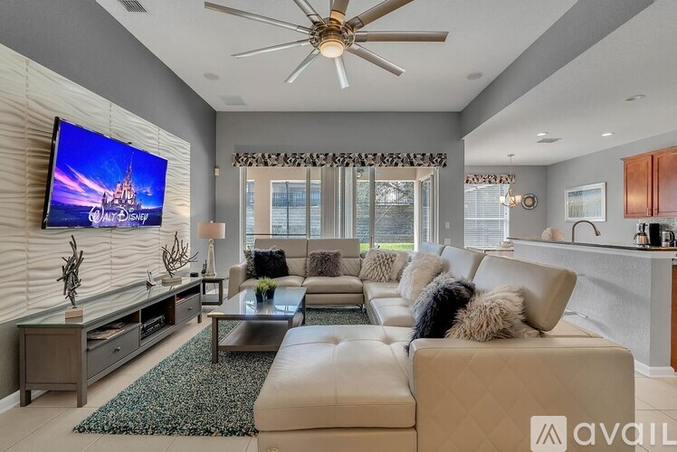 A modern living room with a flat screen TV mounted on the wall.