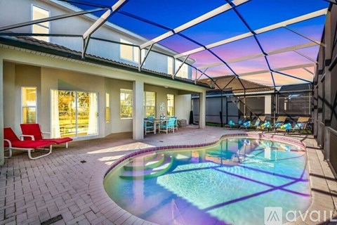 A pool in a house with a glass ceiling.