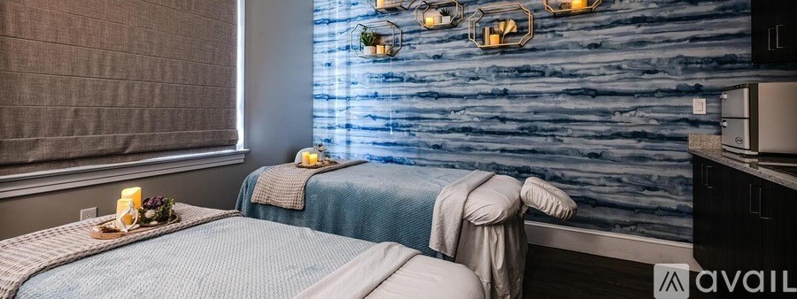 A room with two beds and a wooden wall.