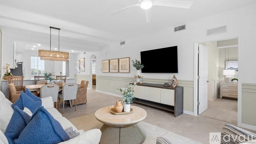 A living room with a white couch and a coffee table.