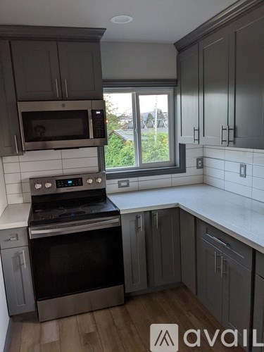 A kitchen with a stove top oven and microwave.