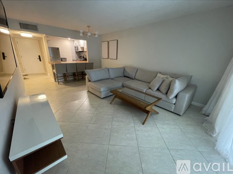 A living room with a grey couch and a wooden coffee table.