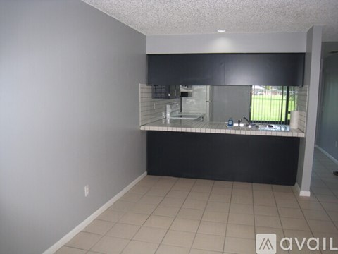 A kitchen area with a counter and a sink.