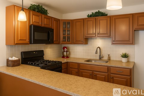 A kitchen with brown cabinets and a black stove top.