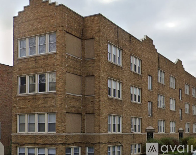 A tall brick building with many windows.