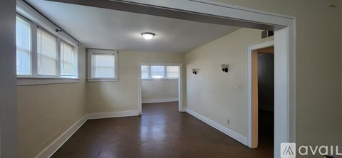 A room with a window and a door is available for rent.