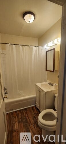 A bathroom with a toilet, sink, and bathtub.