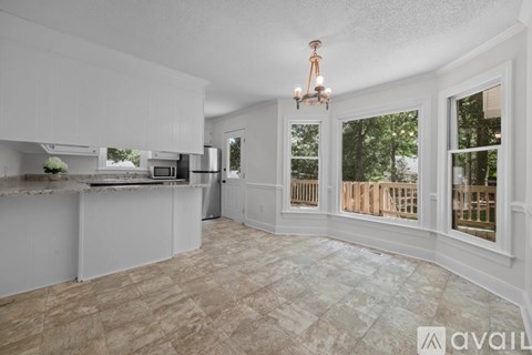 A kitchen with a counter and a fridge.