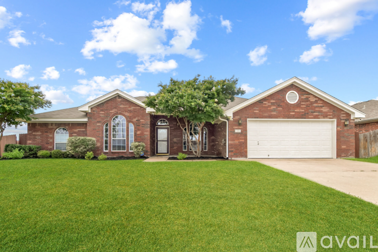 A house with a garage and a driveway in front.