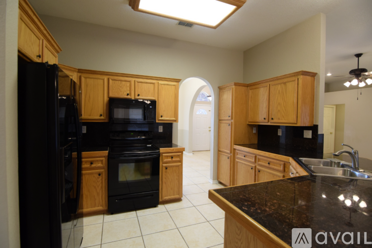A kitchen area with a counter and cabinets.